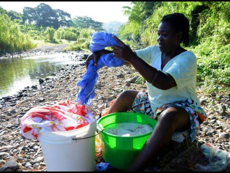 Credit: Ian Allen Maria Hall-Gallimore was among the persons doing laundry when The STAR visited Lucky Valley in Clarendon.
