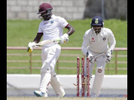 India wicketkeeper Wriddhiman Saha (right) stumps Windies batsman Jermaine Blackwood, of Jamaica, during day five of their third Test match at the Daren Sammy Cricket Ground in Gros Islet, St Lucia.