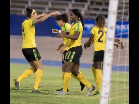 Jamaica’s Khadija Shaw (third from left) celebrates after scoring her  second goal with her teammates as the Reggae Girlz beat  Panama 3-1 at the National Stadium yesterday.