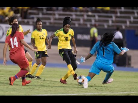 Reggae Girl Shakira Duncan (second from right) scores Jamaica’s third goal against Panama yesterday at the National Stadium.