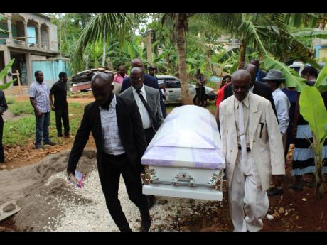 Pall-bearers carry the coffin bearing the remains of Cyslin Brown on Saturday.