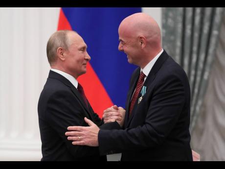 Russian President Vladimir Putin (left) shakes hands with FIFA President Gianni Infantino during an award ceremony at the Kremlin in Moscow, Russia, yesterday.
