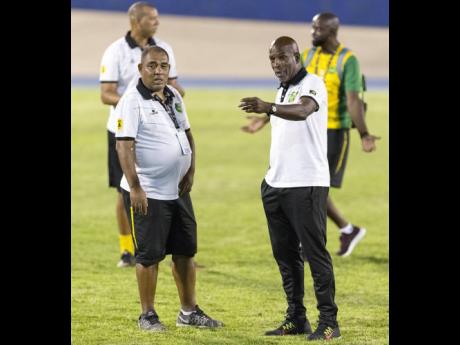 Jamaica senior women’s team head coach Hue Menzies (left) in discussion with his assistant, Lorne Donaldson, after the Reggae Girlz’s Concacaf Caribbean Women’s Qualifier match against Antigua at the National Stadium on Saturday, August 25, 2018. 