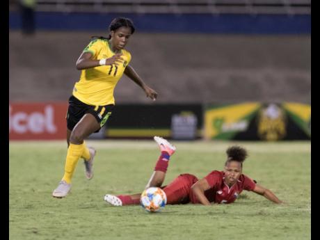 Credit: Gladstone Taylor Reggae Girl Khadija ‘Bunny’ Shaw (left) dribbles to goal after beating Panama defender Yorima Pinzon during their international friendly match at the National Stadium on Sunday, May 19.