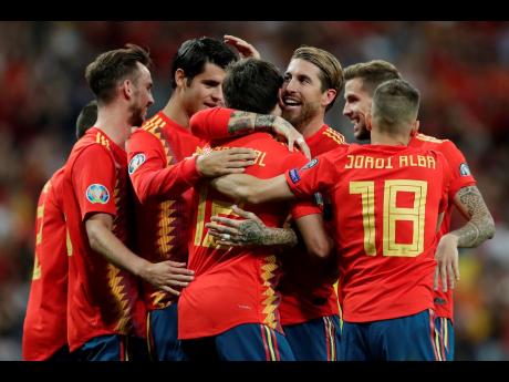 Spain’s Mikel Oyarzabal (centre front) celebrates with teammates after scoring his side’s third goal during the Euro 2020 Group F qualifying match between Spain and Sweden at the Santiago Bernabeu stadium in Madrid yesterday.