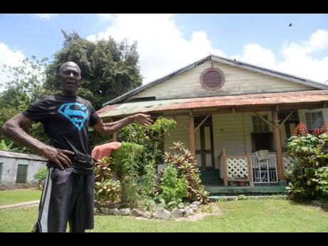 Michael ‘Fox’ Hutchinson says the railway house behind him has been occupied by his family for five decades. 