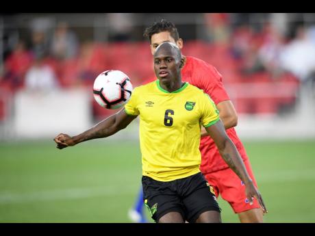 Jamaica forward Dever Orgill (6) watches the ball against United States defender Omar Gonzalez (back) during the second half of an international friendly soccer match, last Wednesday.