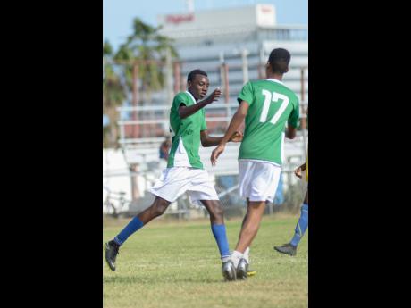 Tivoli Gardens’ Under-17 player Junior Walker (left) celebrates with teammate Jalon Blair after scoring Tivoli’s third goal  against Santos  during the Edward Seaga Sports Festival at the Edward Seaga Sports Complex in the western Kingston community yesterday.