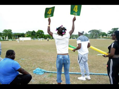 A young spectator celebrates a boundary at a SDC/Wray & Nephew T20 match at Goodyear Oval in St Thomas last month.