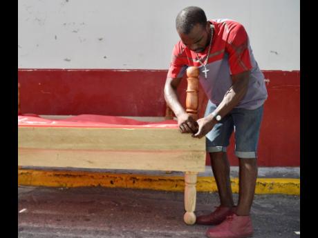 Bryce fine-tunes one of the beds he made. 