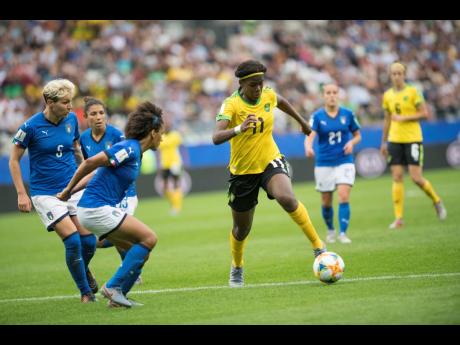 Jamaica’s Khadija Shaw (right foreground) goes on the attack against Italy’s (from left) Elena Linari, Elisa Bartoli and team captain Sara Gama in the Group C FIFA Women’s World Cup match at Stade Auguste-Delaune in Reims, France, on Friday June 14. Jamaica lost 5-0.