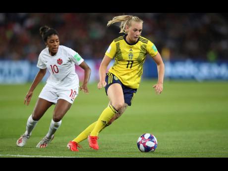 Sweden’s Stina Blackstenius is being chased by Canada’s Ashley Lawrence during the Women’s World Cup round-of-16 match at Parc des Princes in Paris, France, yesterday. Sweden won 1-0.