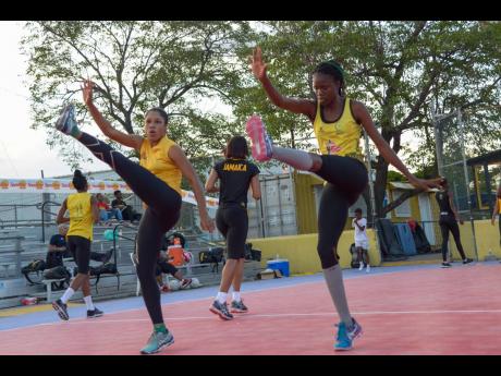 Credit: Shorn Hector Adean Thomas and Nicole Dixon execute a warm-up drill as the Sunshine Girls get ready for the Netball World Cup in July.