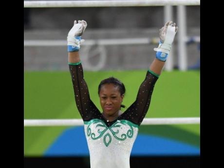 Toni-Ann Williams raises her arms after completing one of her routines at the Rio de Janeiro Olympic Games in 2016.