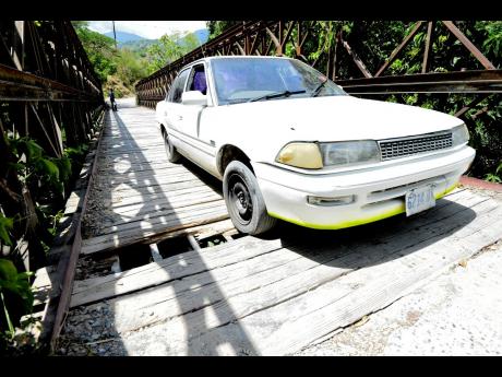 A brave motorist makes his way across the bridge.
