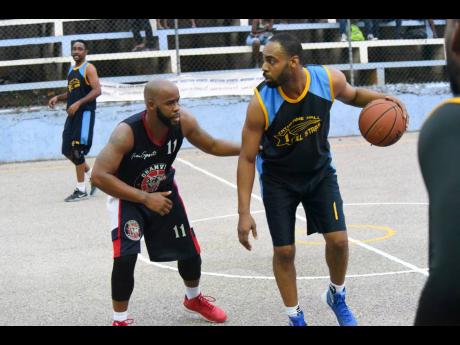 Kavarly Arnold 
Levar Rose (left), then of Granville Jaguars, guards Vaughn Corke of Catherine Hall All-Stars in a 2018 game.