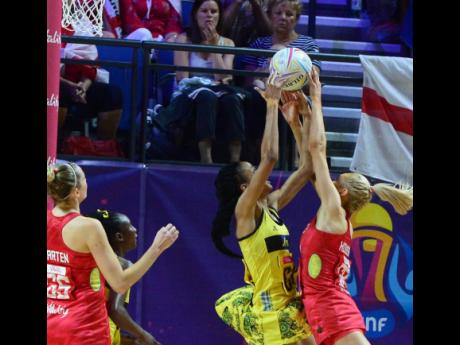 Credit: Collin Reid Romelda Aiken reaches for the ball as England’s Geva Mentor challenges.