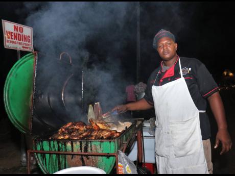 Photo By Adrian Frater
Pan chicken vendor Dwayne ‘Sugar’ Senior is looking forward to good sales this Sumfest week, now that downtown Montego Bay has been designated a special entertainment zone.