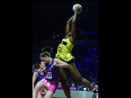 Jamaica captain Jhaniele Fowler’s (right) physical presence is too much for Scotland’s Emily Nicholl as she outjumps her to claim a pass.