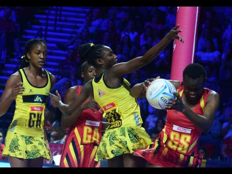 Jamaica’s Jodian Ward (second right) challenges Uganda’s Stella Oyella (right) for the ball as Kadie-Ann Dehaney (left) and Racheal Nanyonga look on.