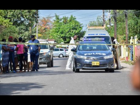 Police cordon off the scene of a murder-suicide on Waltham Park Road, St Andrew, on April 10. 