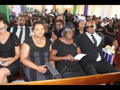 Family members of the late Neville Croasdale at his funeral, held at the William Knibb Baptist Church yesterday.