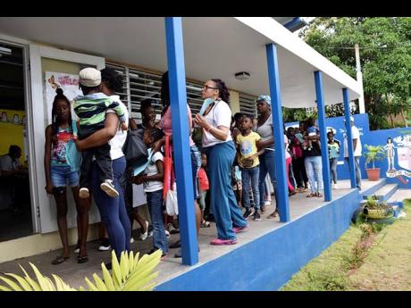 Residents of the Brandon Hill  community in Clarendon, patiently wait to be seen by the medical team.