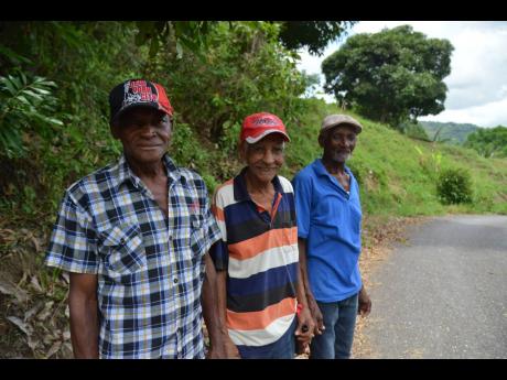 Veteran donkey riders Adolphus McDonald (left), Roy Richards (centre) and his brother Fitz Richards talk about the history of the Top Hill donkey race which was staged for the 25th year yesterday.