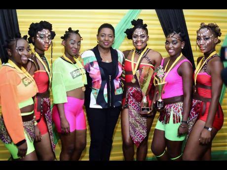 Culture Minister Olivia Grange (centre) with members of Afro Jam Tribe, who finished second and won best costumed group.