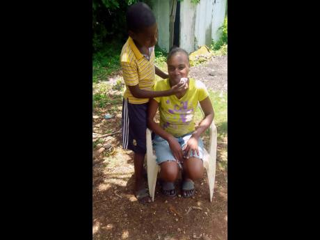 Credit: . Merrick wipes sweat from his mother Ann-Marie Williams face