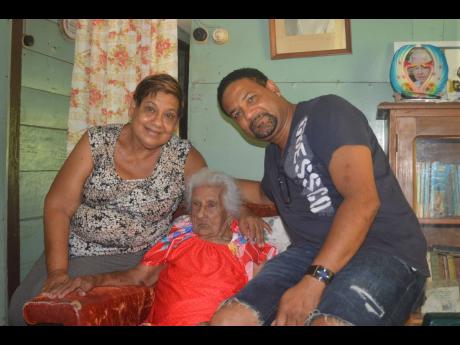 Olive Luckie (centre) with her daughter Viviene Luckie and grandson Colin Gordon. Luckie celebrated her 106th birthday on July 31.
