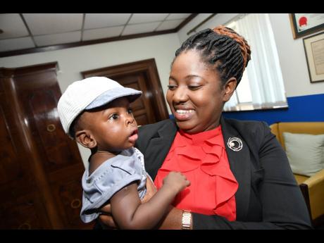 Tamar Blake meets seven-month-old Sae'breon Hutton for the first time. Blake was instrumental in uniting the child with his parents shortly after birth.