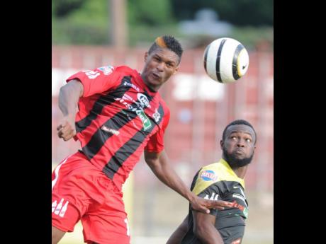 FILE
Andre Clennon, formerly of Arnett Gardens, wins a header over Ramone McGregor of Barbican in a Red Stripe Premier League match on January 18, 2015.