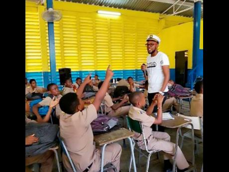 Credit: Contributed Taylor interacts with students as he explains what he does for a living.