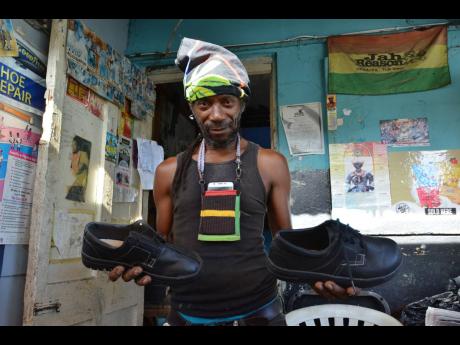 Kenneth Allen shows off two of his creations.