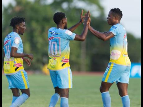 Credit: Gladstone Taylor Waterhouse FC’s Stephen Williams (right) celebrates his goal scored against Real Hope Football Academy, with teammates Andre Fletcher (left) and Kenroy Howell, in the FLOW Concacaf Caribbean Club Championship match at Stadium East in Kingston, on Tuesday, May 14.