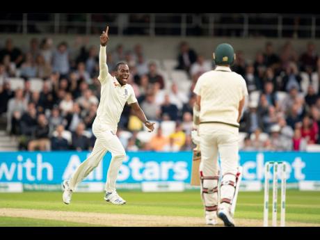 England’s Jofra Archer celebrates after taking his fifth wicket, that of Australia’s Pat Cummins (right) caught by Jonny Bairstow for 0 on the first day of the third Ashes Test cricket match between England and Australia at Headingley cricket ground in Leeds, yesterday.