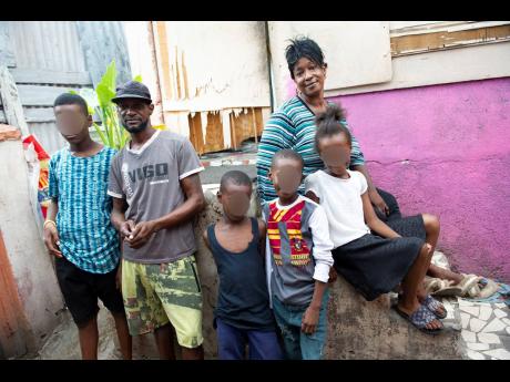 Ricardo Makyn/Chief Photo Editor
Leecroft Dunnigan and his common-law wife, Jaqueline Shirley, pose with their children at their home on Wildman street, downtown Kingston.