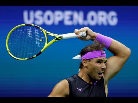 Rafael Nadal, of Spain, returns a shot to John Millman, of Australia, during the first round of the U.S. Open tennis tournament yesterday.