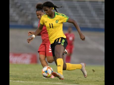 Credit: Gladstone Taylor Jamaica's Khadija Shaw dribbles to goal while under pressure from Yomira Pinzon of Panama during an international friendly played at The National Stadium on Sunday May 19, 2019.