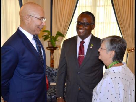 Governor-General Sir Patrick Allen (left), converses with Manchester businessman and newly appointed Custos Rotulorum for the parish, Garfield Green, and outgoing Custos, Sally Porteous, during Green's swearing-in ceremony at King’s House in June.