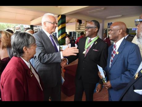 New Custos of Manchester Garfield Green (second right) jokes with (from left) former custos Sally Porteous, Justice Minister Delroy Chuck, and Custos of Kingston Steadman Fuller at his installation ceremony in Mandeville recently.