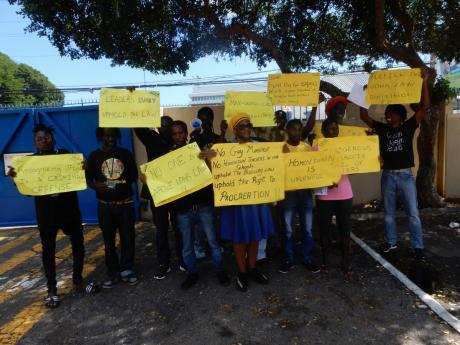 Members of the Kingdom of Debre Zeit group show their placards at the Gleaner Company Media Limited’s office yesterday.