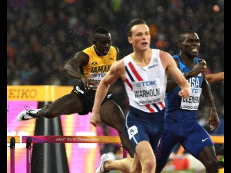 File 
Kemar Mowatt (left) clears the final hurdle in the men’s 400m hurdles final at the London World Championships as Norway’s Karsten Warholm (second right),  runs home to claim his first global title in 48.35 seconds. USA’s Kerron Clement was third in 48.52.