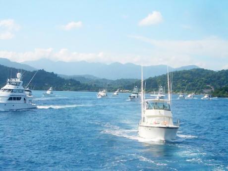  Boats sail out into the sea during the Port Antonio Blue Marlin tournament last year.