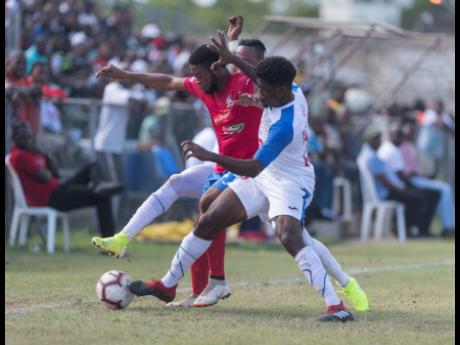 Dean-Andre Thomas of Dunbeholden (left) is contested by Roshane Sharpe of Portmore United for possession of the ball in their Red Stripe Premier League match at the Spanish Town Prison Oval on September 15.