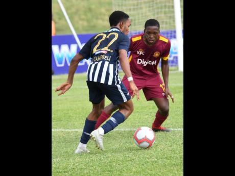Nickari Campbell (left) of Jamaica College tries to get by Christopher Matthews of Wolmer’s Boys School in a ISSA/Digicel Manning Cup game at Stadium East on Monday, September 16, 2019. The game was called off after five players were reportedly struck by lightning.