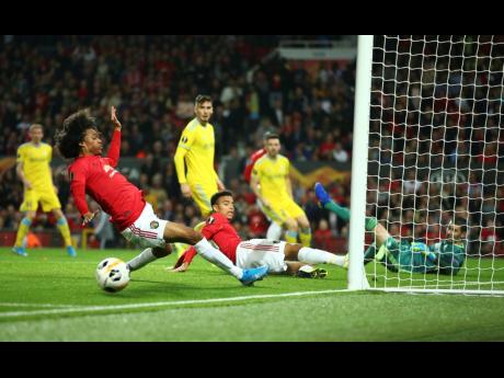 Manchester United’s Tahith Chong (left) fails to score during the Europa League Group L match between Manchester United and Astana at Old Trafford stadium in Manchester, England, yesterday.