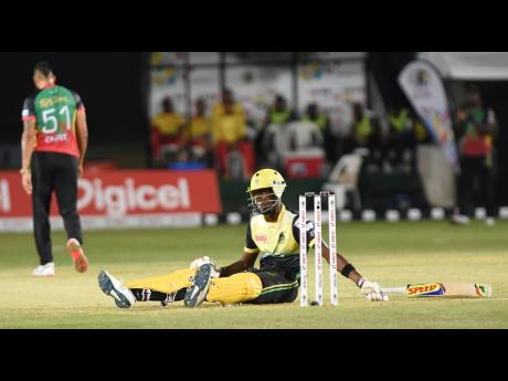 Shamar Springer from the Jamaica Tallawahs was left flat on the ground after a wild swing and miss off the bowling of Rayad Emrit in a Caribbean Premier League at Sabina Park yesterday.