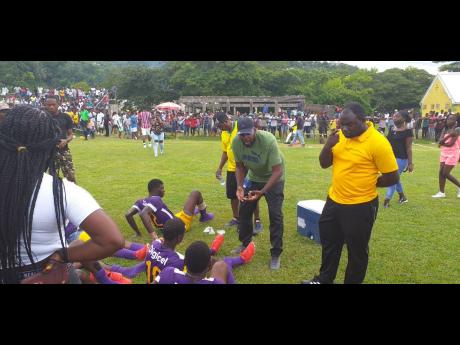 Head coach of Happy Grove, Vincent Wallace, conducting team talk during Saturday’s daCosta Cup against Titchfield High School at Carder Park in Port Antonio.

